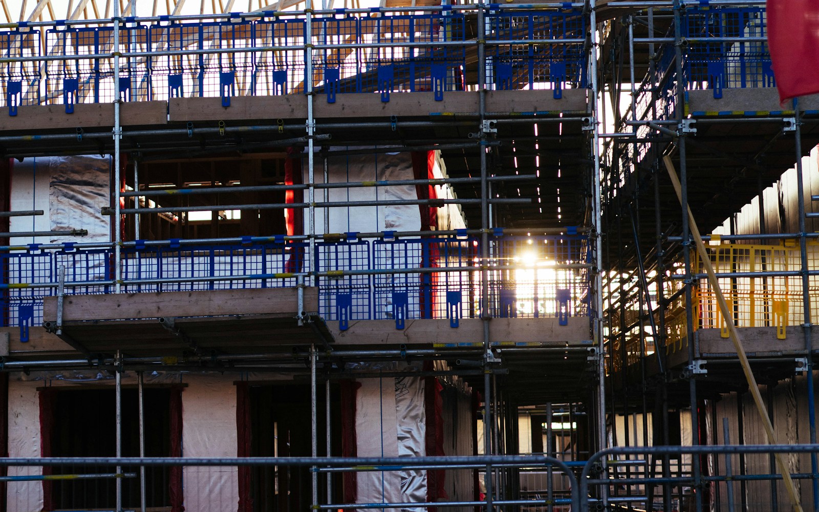 Commercial building under construction with scaffolding and active turnover work.