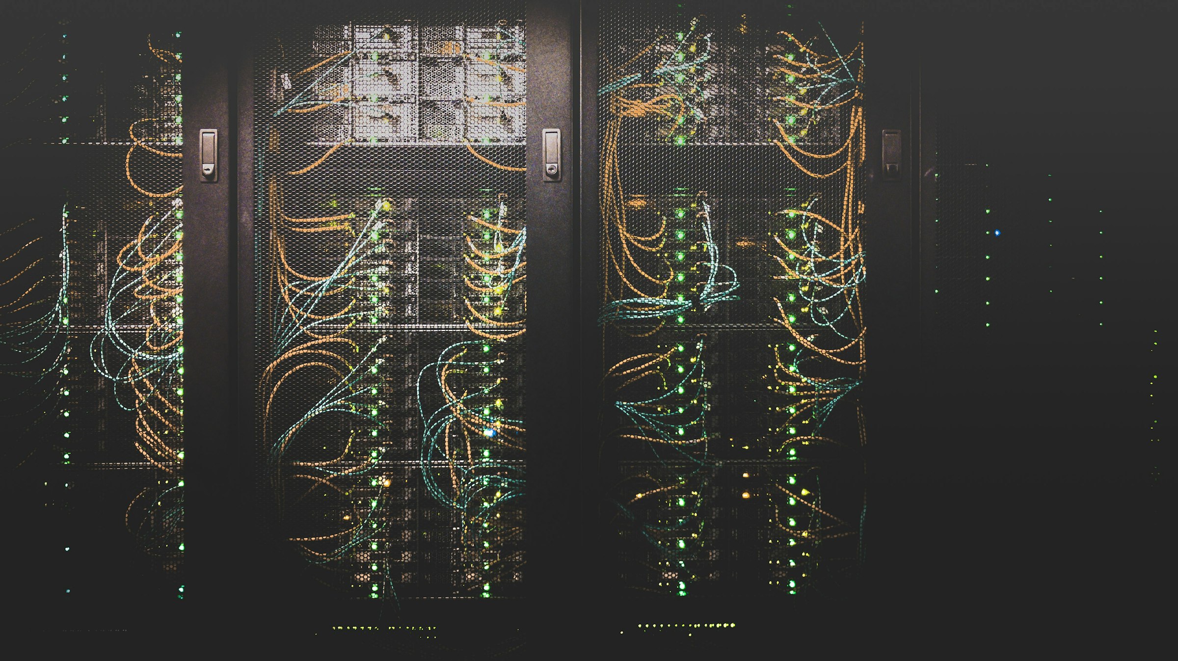 Blue-lit server room cabling in a Northern Virginia data center, representing the critical-environment standards a cleaning partner must meet